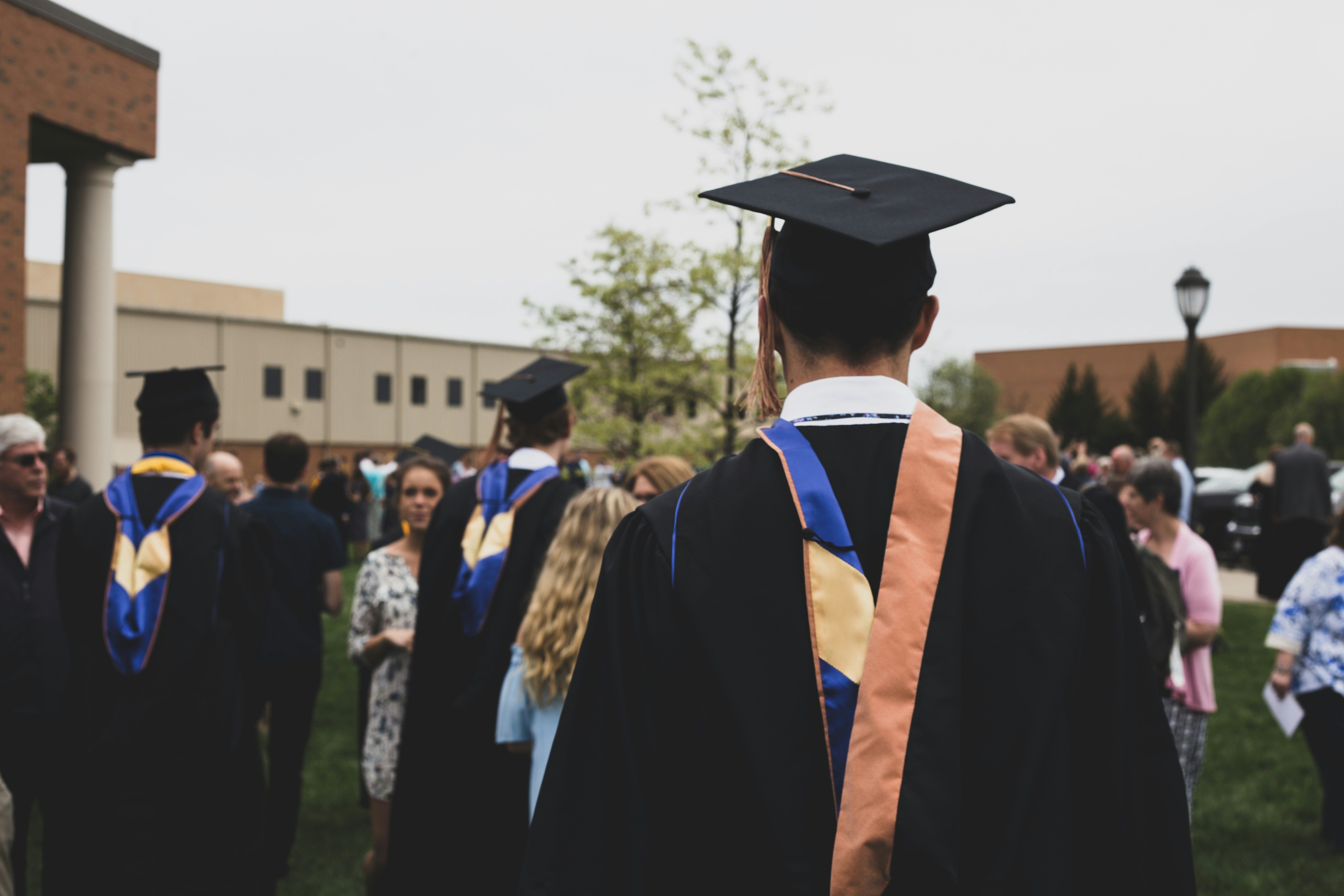 backside view of college graduate looking forward