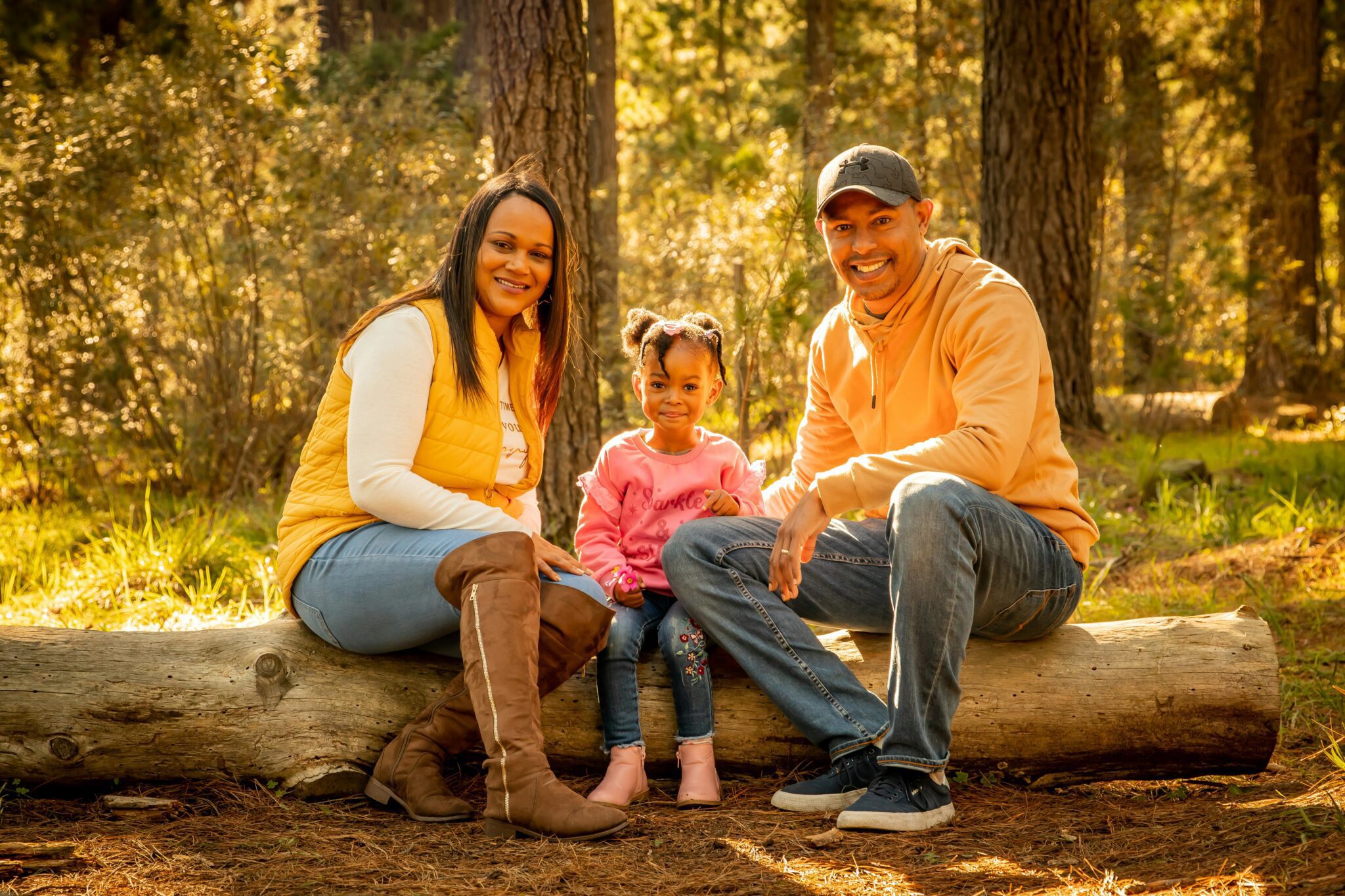 Three generations of a family smiling together outdoors in a forest, representing family legacy and structured wealth transfer